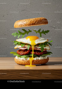 Fresh gourmet sandwich with runny fried egg and greens