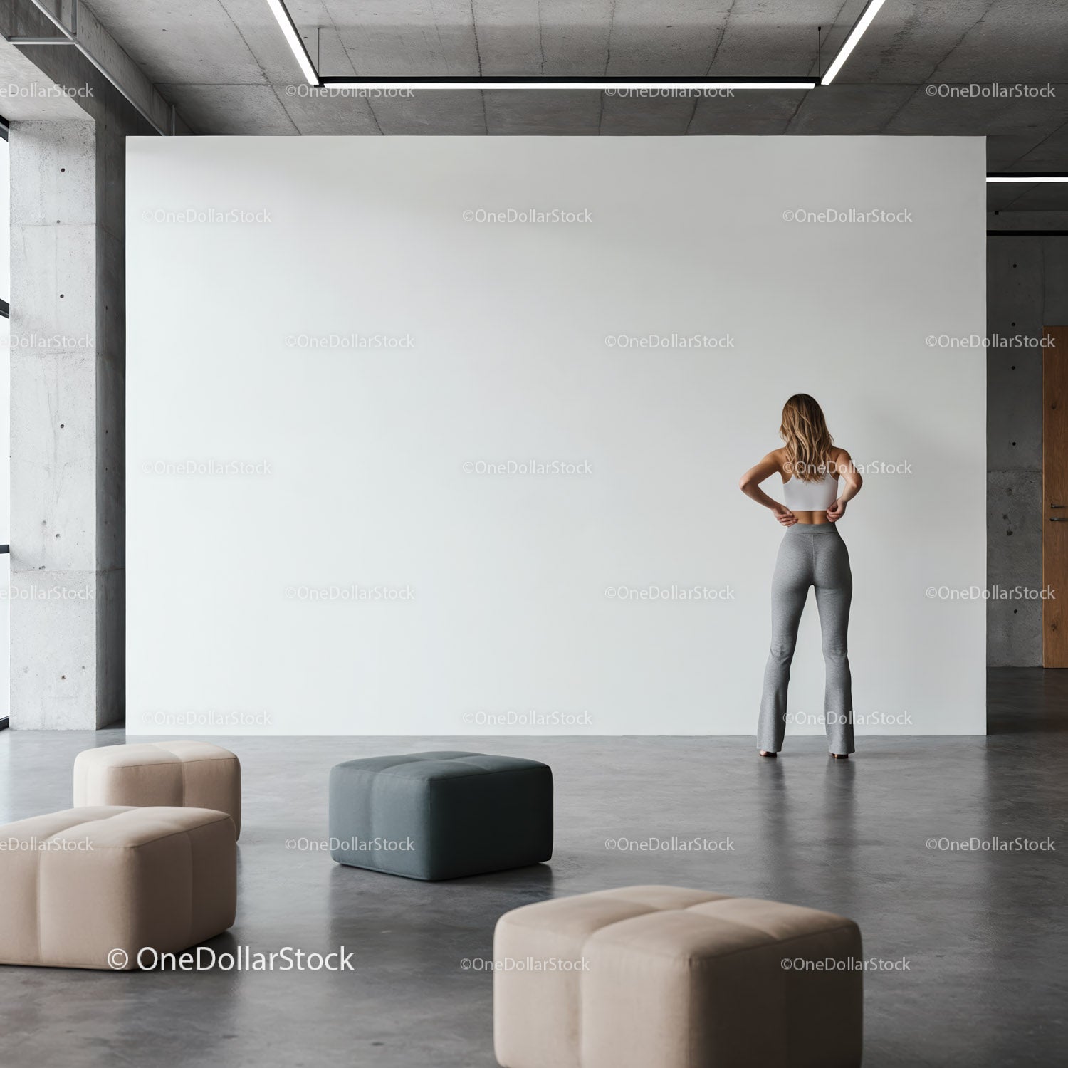 Woman standing contemplatively in modern minimalist space