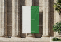 White and green vertical flag hanging on stone columns