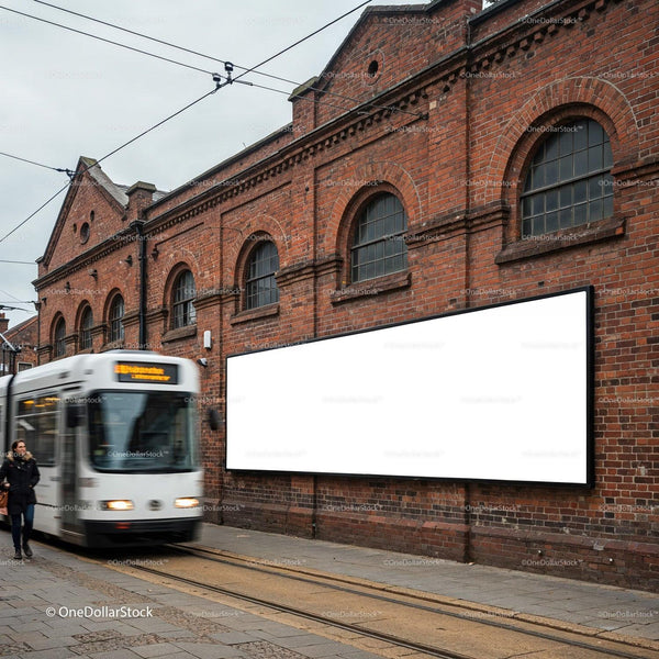 Urban tram passing by brick wall with blank billboard JPG Mockup Image