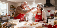 Senior couple playfully baking heart cookies together