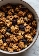 Crunchy granola clusters with dried berries in bowl