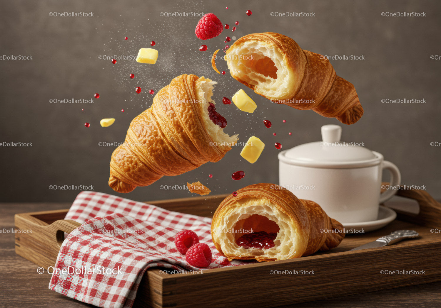Fresh croissants with raspberry jam and butter on tray