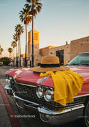 Vintage Pink Car with Straw Hat and Yellow Dress Fabric in Sunset