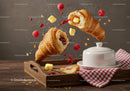 Flying croissants with butter raspberry jam splash