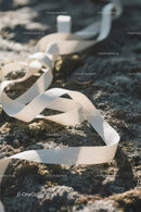 White Ribbon on Rocky Shoreline with Ocean in Background
