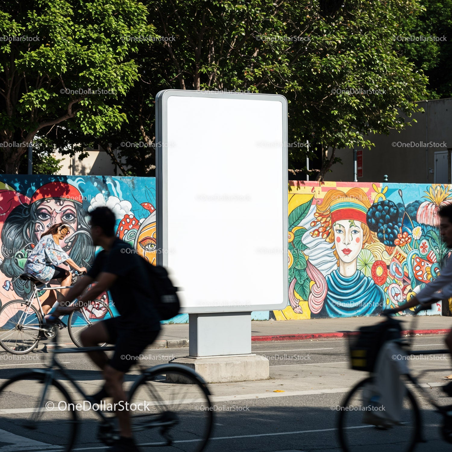 Urban cyclists passing blank billboard with colorful mural