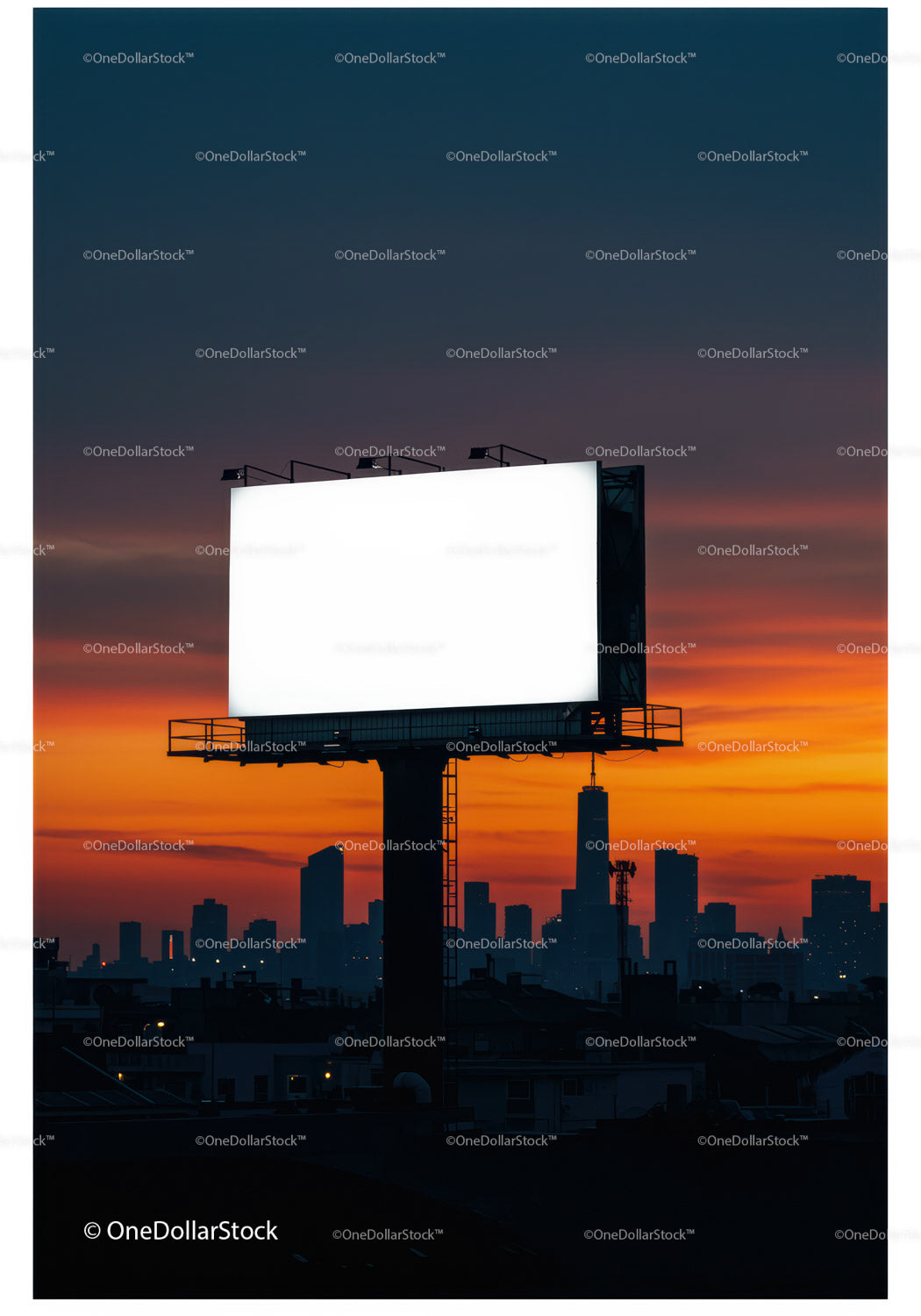 Blank billboard glowing above city skyline at sunset