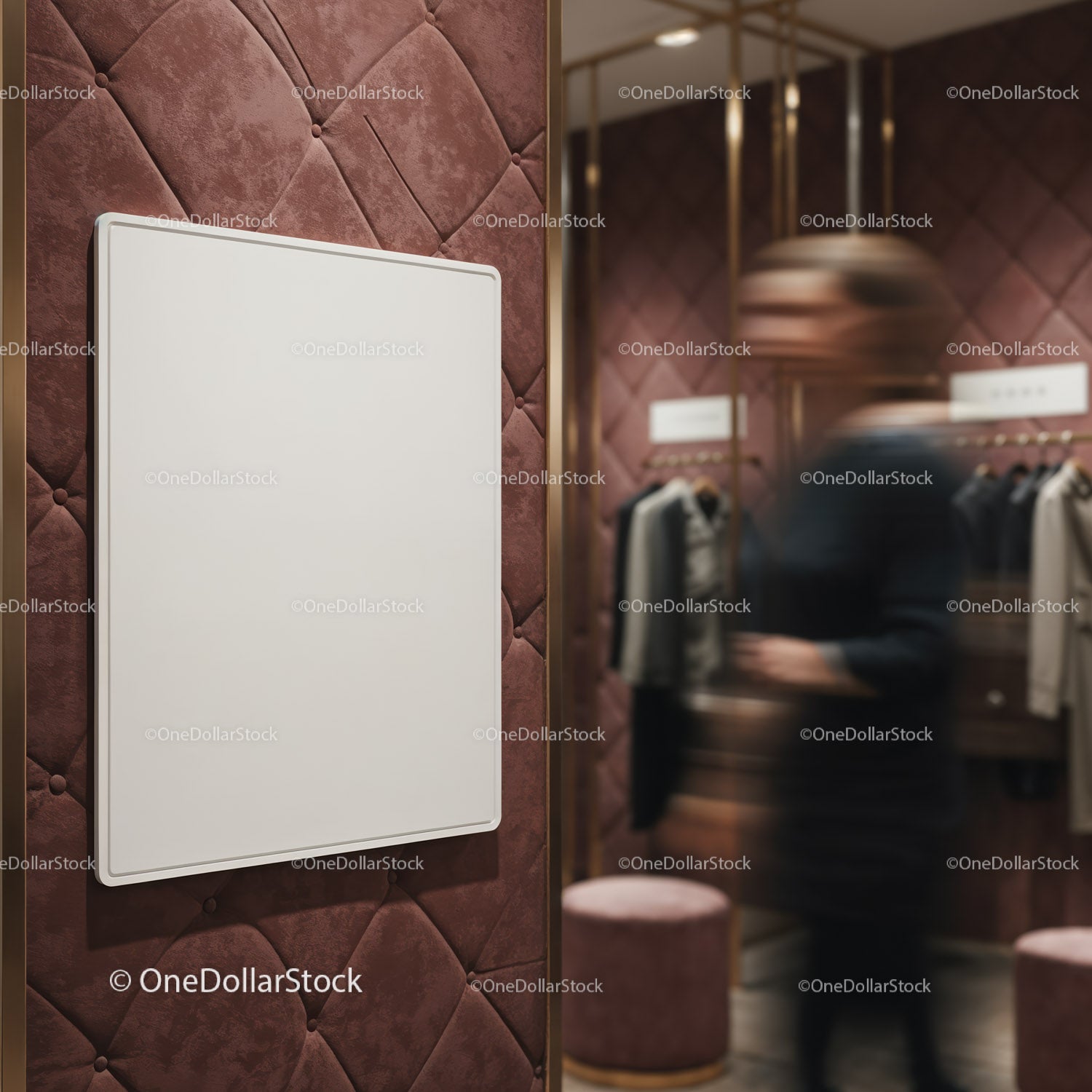 Blank poster on quilted wall in stylish clothing store