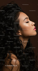 Profile of a woman with curly hair and soft makeup