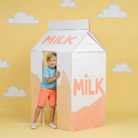 Smiling boy playing inside giant milk carton prop