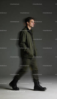 Man walking confidently in casual military-inspired outfit