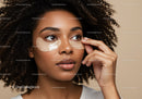 Young woman applying moisturizing face mask with curly hair