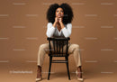 Stylish Confident Woman Sitting on Chair in Modern Studio