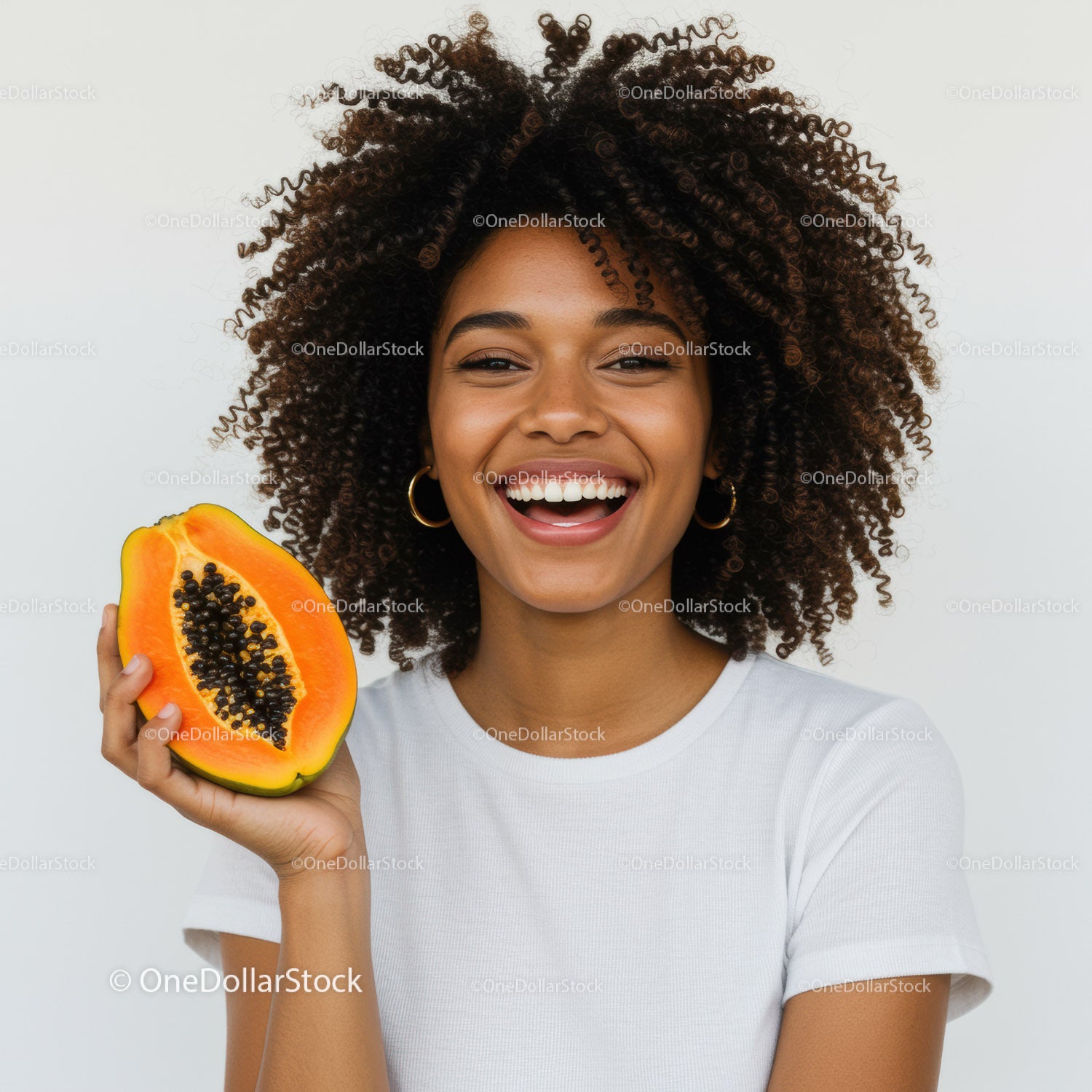 Smiling Woman with Curly Hair Holding Juicy Papaya