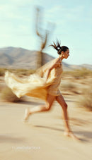 Woman Running in a Desert Landscape with Cacti