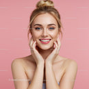 Bright Smile of a Woman with Blonde Hair and Blue Eyes against Pink Background
