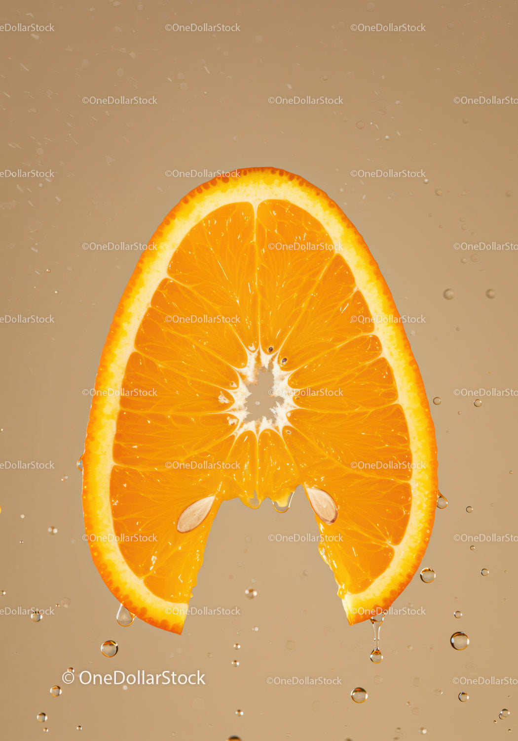 Fresh orange slice dripping with juice in water