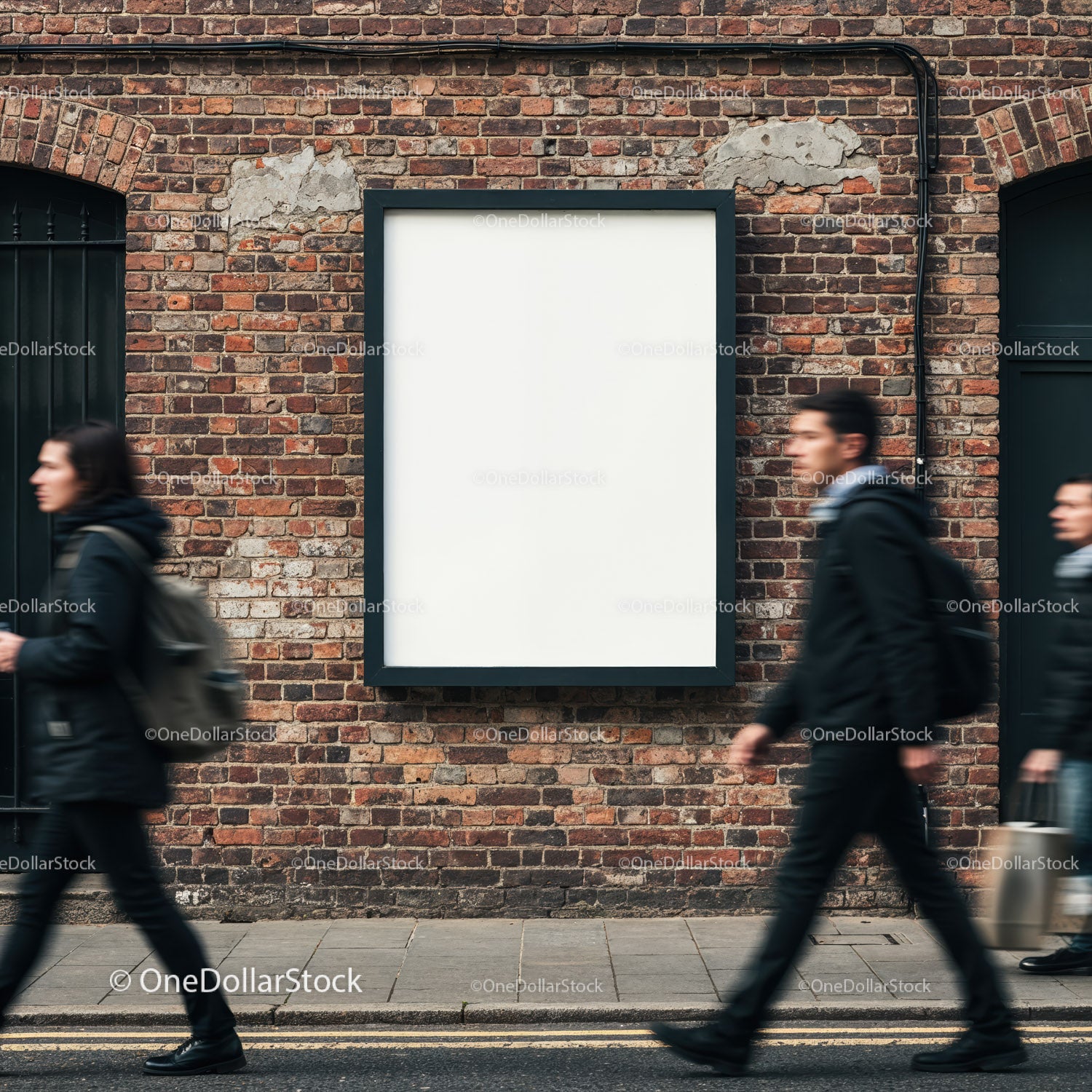 Empty billboard on brick wall with blurred city walkers