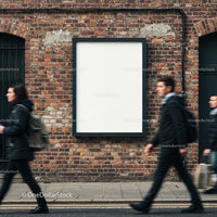 Empty billboard on brick wall with blurred city walkers