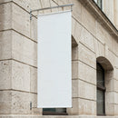 Blank Vertical Banner Hanging on Stone Building Façade