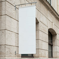Blank Vertical Banner Hanging on Stone Building Façade