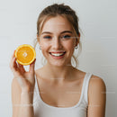 Bright and Cheerful Smiling Woman with Orange Slice in Studio