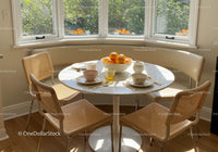 Cozy breakfast nook with natural light and fresh oranges