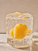 Yellow apricot encased in clear ice cube