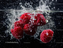 Fresh Raspberries Splashing in Water Creating a Vibrant Fruit Scene