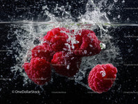 Fresh Raspberries Splashing in Water Creating a Vibrant Fruit Scene