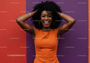 Vibrant Joyful Woman in Orange Dress Against Colorful Wall