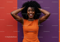 Vibrant Joyful Woman in Orange Dress Against Colorful Wall