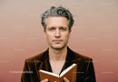 Stylish Middle-Aged Man Reading Book in Modern Interior