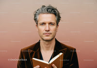 Stylish Middle-Aged Man Reading Book in Modern Interior
