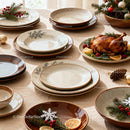 Rustic holiday table setting with roasted chicken and decor