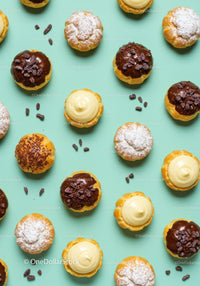 Assorted cream-filled dessert tarts on pastel background