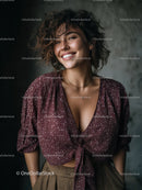 Stylish Woman with Curly Hair Smiling in Casual Outfit