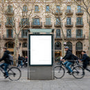 Urban street scene with cyclists and blank billboard