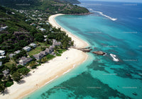 Tropical Beach with Overwater Bungalows and Mountain Backdrop