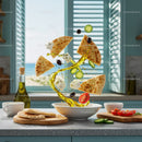 Fresh Mediterranean ingredients swirling over white bowl