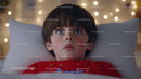 Young Boy Lying in Bed with Blue Eyes in Festive Holiday Bedroom