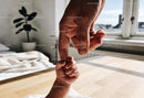 Tender moment of bonding between baby and parent hands