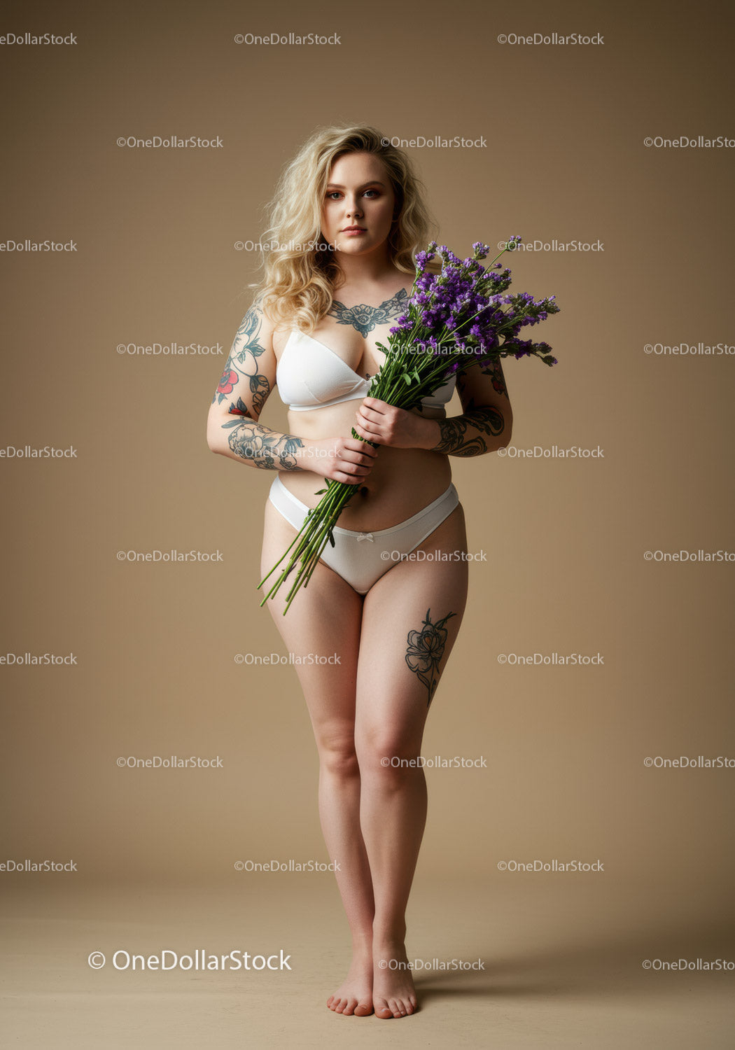 Elegant Blonde Woman with Tattoos Holding Purple Flowers in Studio