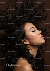 Profile of woman with flowing curly hair on brown background