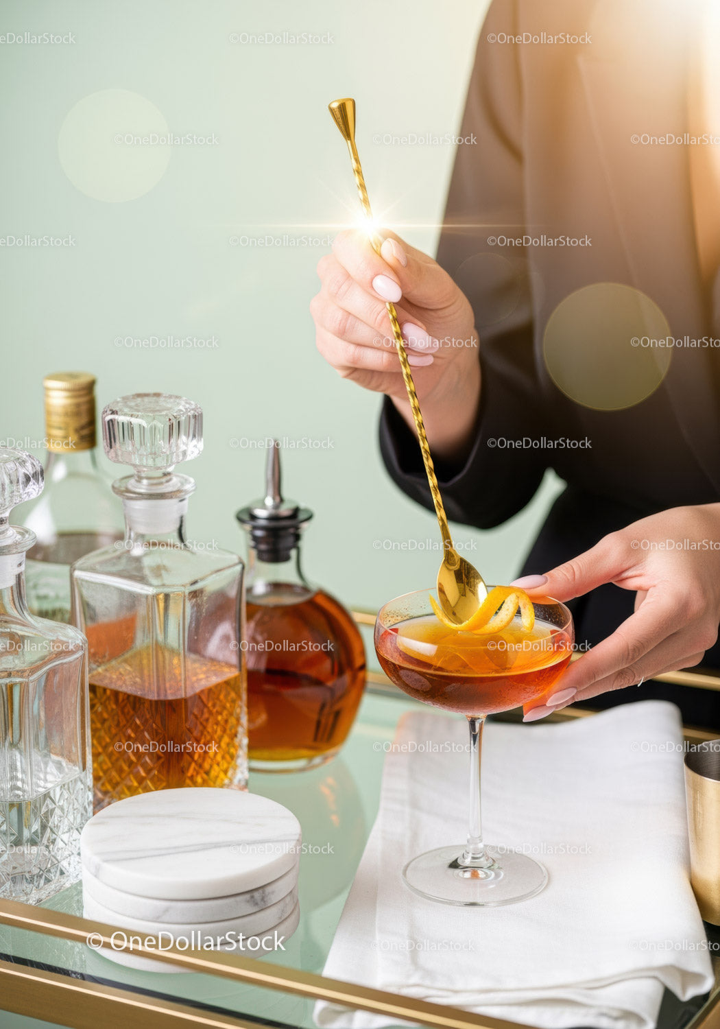 Elegant Cocktail Preparation with Gold Spoon and Barware