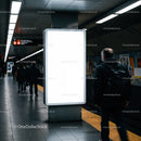Empty illuminated billboard in busy urban metro station
