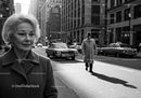 Elderly Woman in Busy City Street Surrounded by Vintage Cars