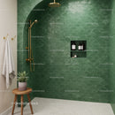 Modern shower space with green scalloped tiles and gold fixtures
