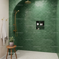 Modern shower space with green scalloped tiles and gold fixtures